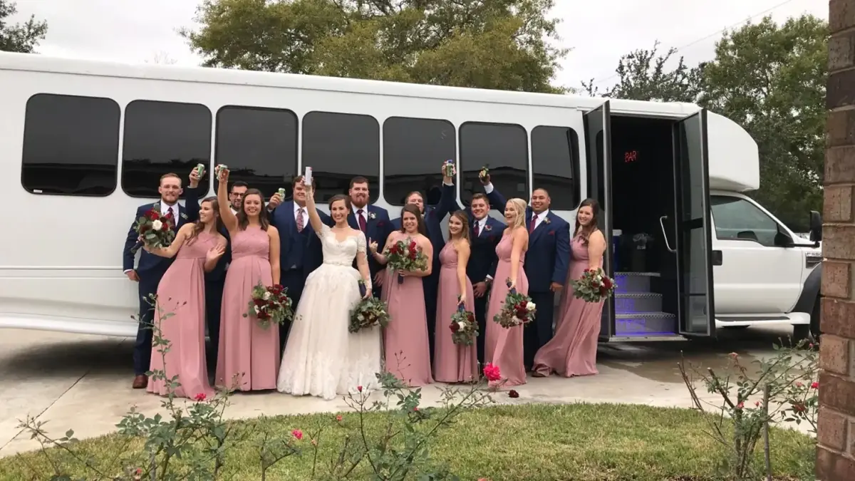 Wedding party in front of the party bus